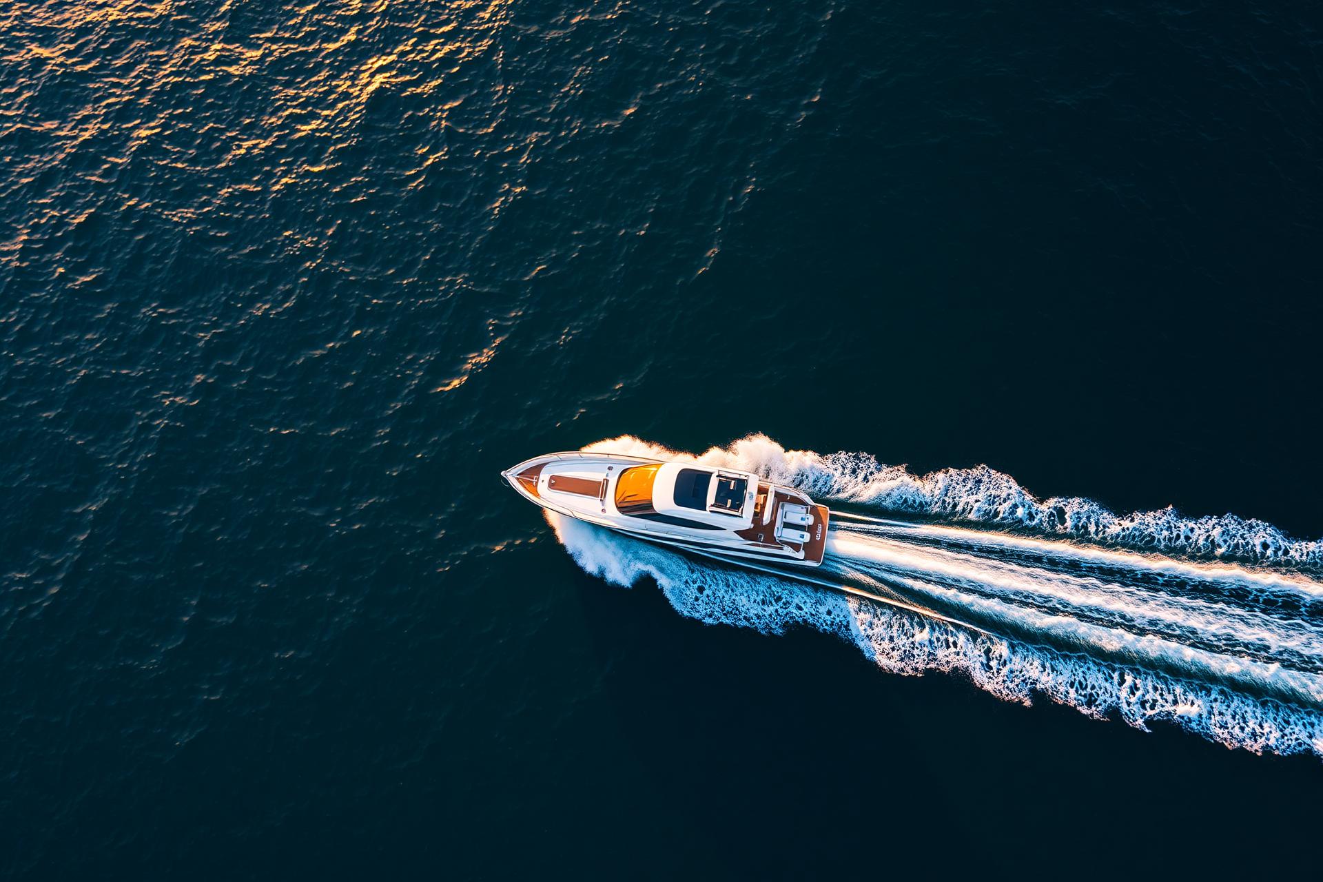 Aerial view of a motorboat cutting through deep ocean water